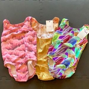 3 girl’s size 6 gymnastics leotards